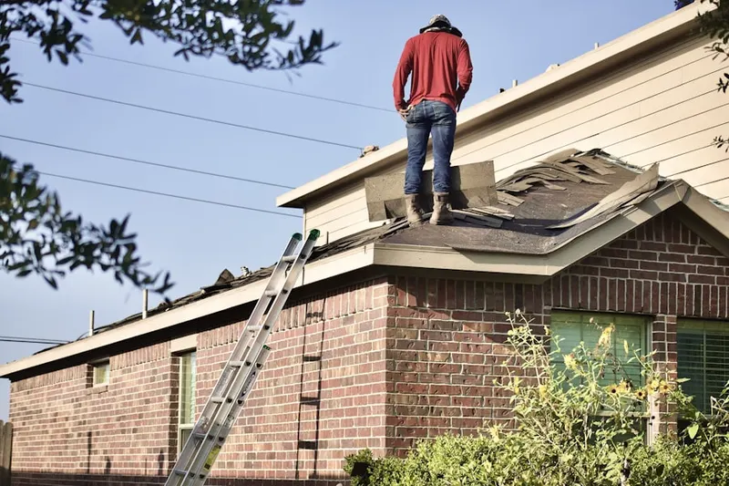 Professional roofer working on a residential roof in Conowingo
